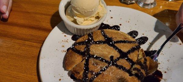 Fresh baked double chocolate cookie with a scoop of vanilla ice cream