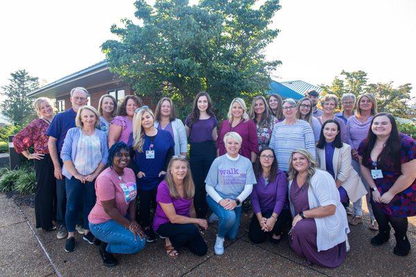 Team photo, wearing purple in support of Alzheimer's Awareness.