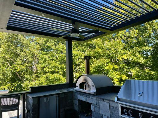 Gorgeous kitchen area protected by StruXure adjustable pergola.