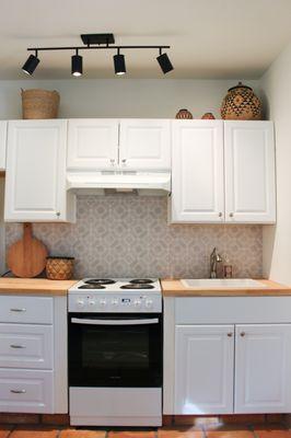 After! Elliot installed butcher block counters, new stove, new backsplash and a new sink!