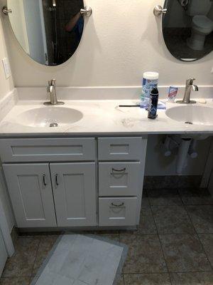 A roll-under vanity provides access for individuals with limited mobility.