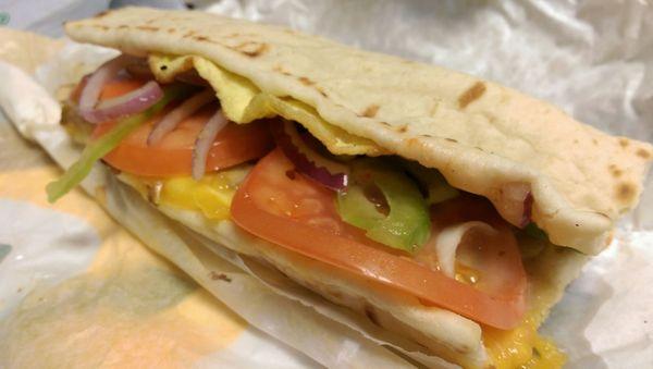 Steak, Egg, and Cheddar Cheese on a White Flatbread with red onion, bell pepper, and tomato topped with honey mustard