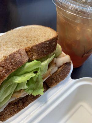 Club sandwich on wheat with Sweet Tea to drink.