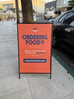 The sign by the door where you pick up your food