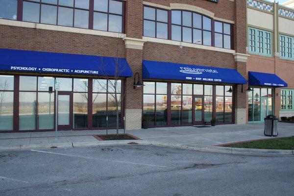 Under the big blue awning next to US Bank