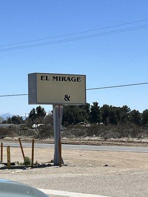 The sign off the highway is easy to miss . But the building is unique, in shape and grey color.