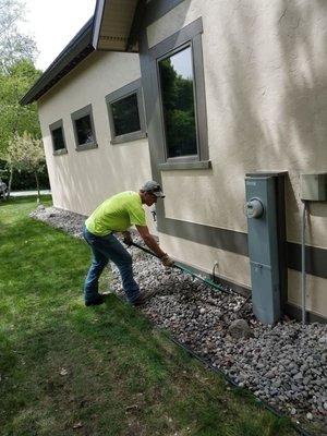 Decorative stone being installed around customers home.