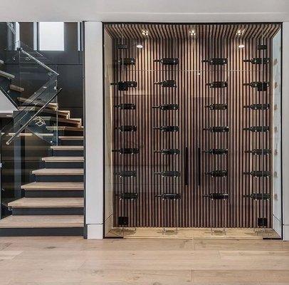 Stunning wine cellar with complementing glass staircase