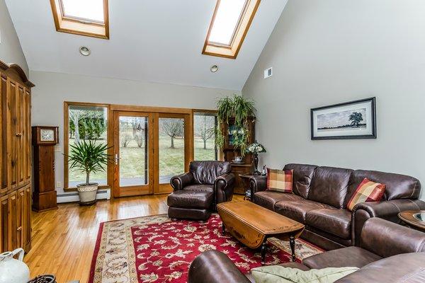 Family Room with Vaulted Ceilings, Skylights and French doors to Deck and Rear yard.