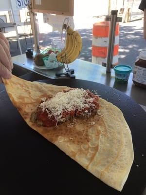 Meatball with tomato sauce and freshly grated cheese.