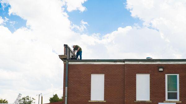 Installing a solar powered time-lapse camera for a two year long recording of the school construction in White Sulphur Springs Montana.