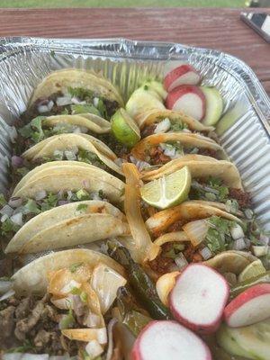 Amazing tray of a dozen tacos.   Came with rice and beans and soda.