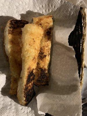 3 pieces of burnt bread on a paper towel