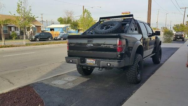 Ford raptor with Addictive Desert Designs chase rack and Rigid lighting.