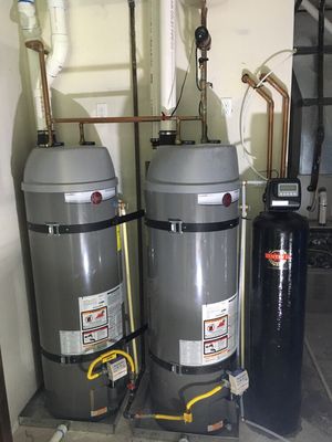 Power vent water heaters set up in reverse parallel piping for optimum efficiency, a hot water recirculating pump, and a water softener.