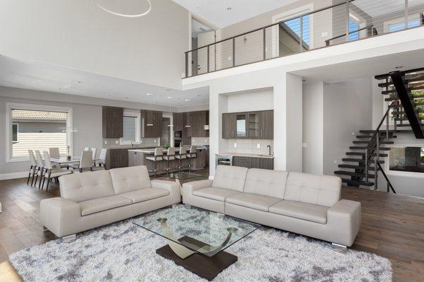 This contemporary great room has an abundance of open space, offering wood grain kitchen and open staircase.