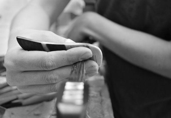 One of our professionally-trained staff completes a bow rehair.