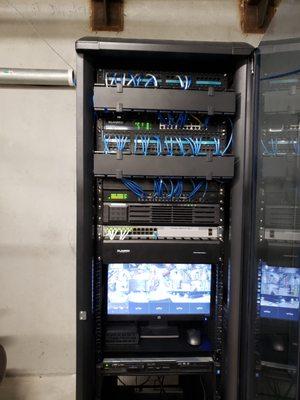 Server room with separate switches for Data and Voice. Includes camera system.