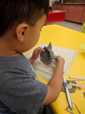 My almost 5yo in mommy and me ceramics class which we loved