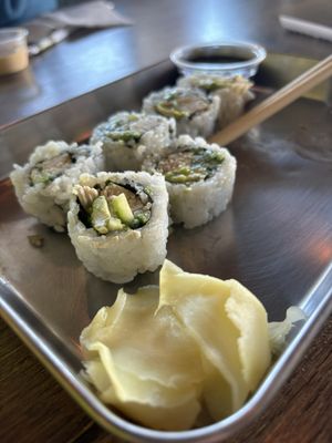 Custom sushi with avocado, chicken, cucumber, and green chili. The eel sauce is also pictured in the top right corner.