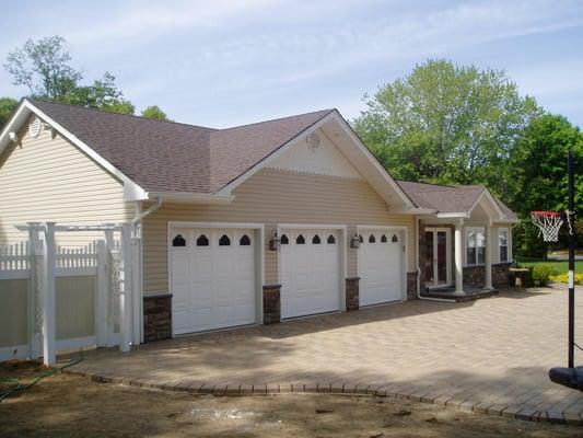 This  is a three car garage and family room and bedroom expansion enhancing the overall look of the existing ranch home.