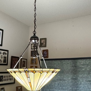 Stained glass pendant light
Vintage chandelier installation
Art Deco lighting fixture