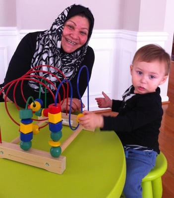 Mama Ezzat with one of her kids in the Sun Shine Home Day Care