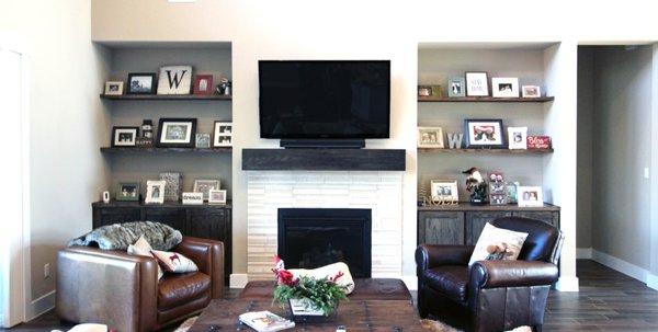 Custom cabinets, floating shelves, and mantle