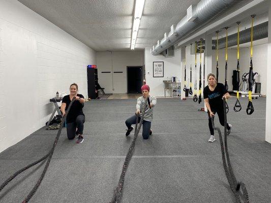 Trainer Rachel (center) and members during battle rope exercises