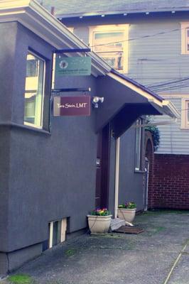 Door to office is between the two flower pots on North side of building (faces Broadway)