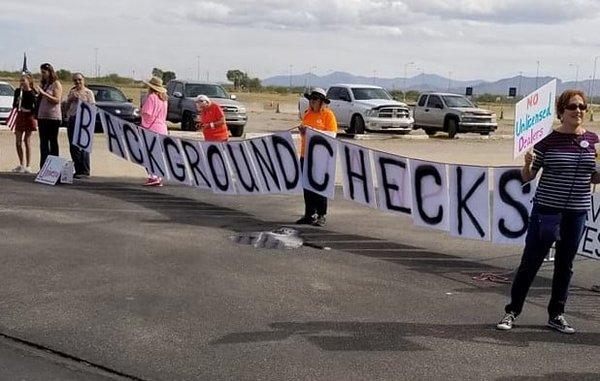 Protesters appear at the gun show to object to the lack of background checks at the gun show.