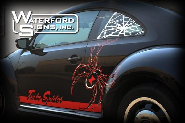 Partial Wrap on a 2012 Volkswagen Beetle with Custom Turbo Striping and Solid Vinyl Webs in the Windows.