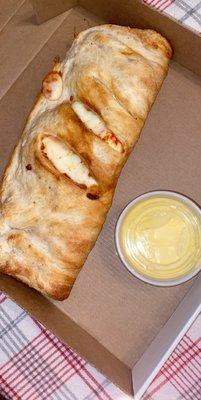 Cheese calzone with garlic sauce