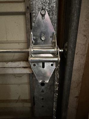 Broken hinge installed in wrong location on the door.