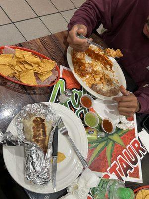 Breakfast burrito . Chicken enchiladas. Chips and salsa . Yummy goodness