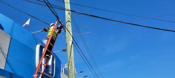 Securing fiber Optics cable on a telephone pole.