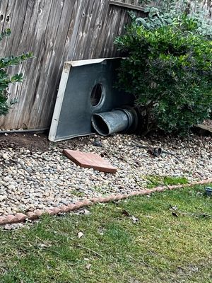 This is my neighbors yard, after the storm, with my chimney cover and cap!