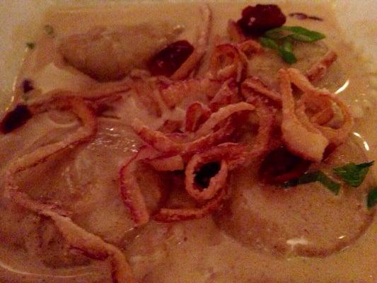 An appetizer special :  Pumpkin Ravioli with cranberries and fried onions (?) in blurred blanc.  Superb.