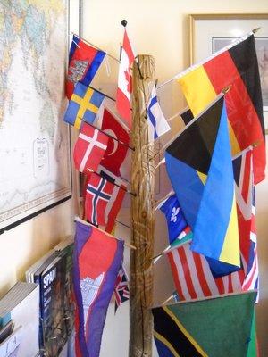 Flags on our "flag tree" brought to us by clients from their travels around the world.