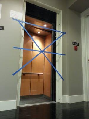 We taped off the elevator door when it was locked in the open position / stuck about a foot below level with the floor.