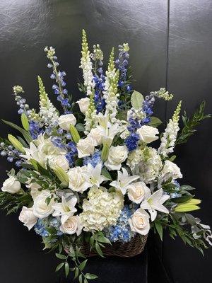 Blue and white flowers, white snaps, blue delph, white hydrangeas, accented with ivory roses