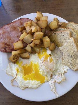 Two eggs breakfast sub ham for bacon and American potatoes for hash browns.