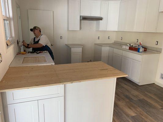 cabinets are "white" but not the same shade of white.   Flawed design I can't open one cabinet