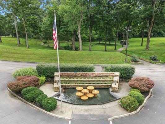 A look at the private park sitting in the front yard of the facility. It includes benches, patio swings, and a walking trail.