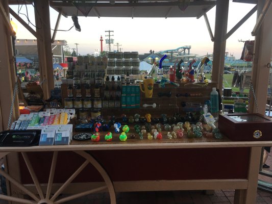 Pic of our kiosk including glass and silicon pipes, vape pens, CBD products and disposable nicotine vapes.