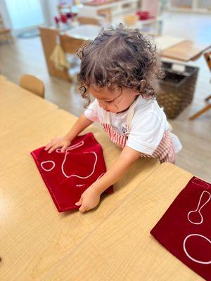 Setting the table to have community snack in a Montessori environment develops concentration