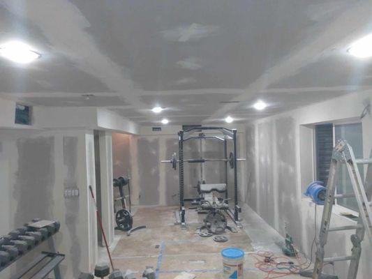 Drywalling and adding lighting and electrical to an unfinished basement, to convert to a theater.