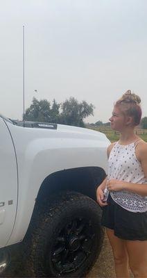 Our daughter next to a spider on the truck antenna.