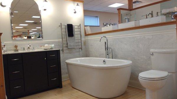 Freestanding soaking tub and towel warmer, examples of very affordable luxury, in our Fishkill Showroom.