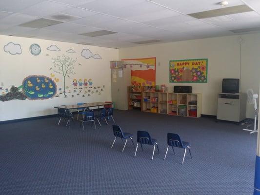 The Hall. Television provided with chairs and little table on a side.